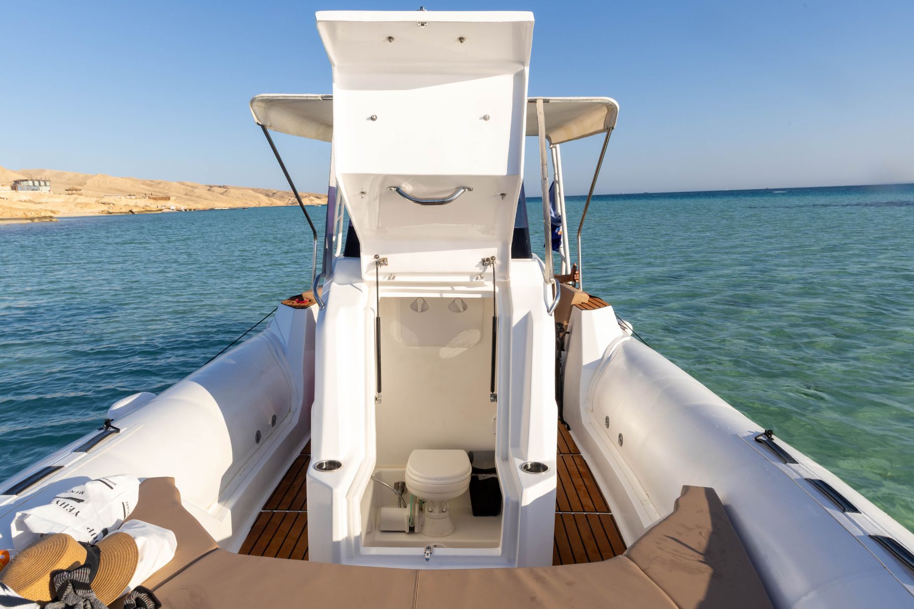 Open compartment on the Promarine X900 showing the private marine toilet on board